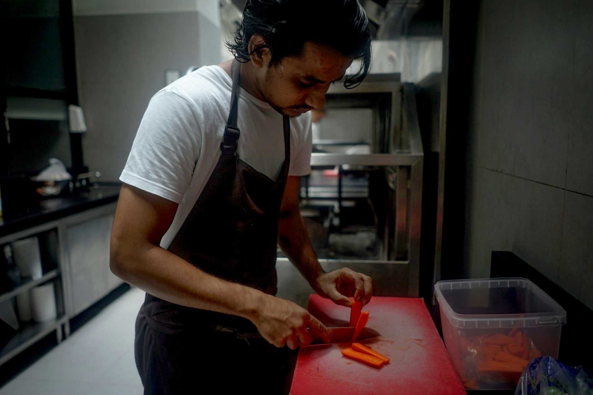 a chef chopping food for care home residents stressing the importance of catering in care homes