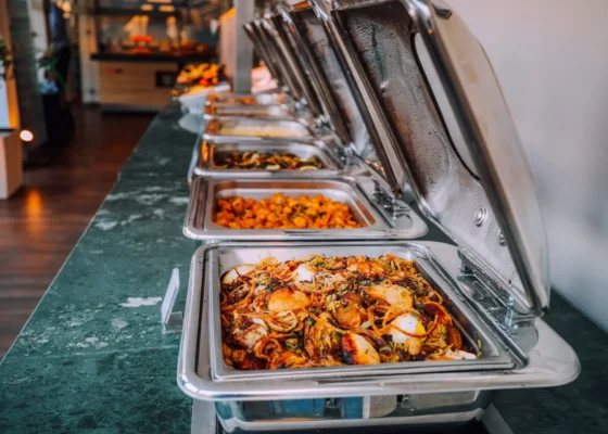 Row of trays with food in them.