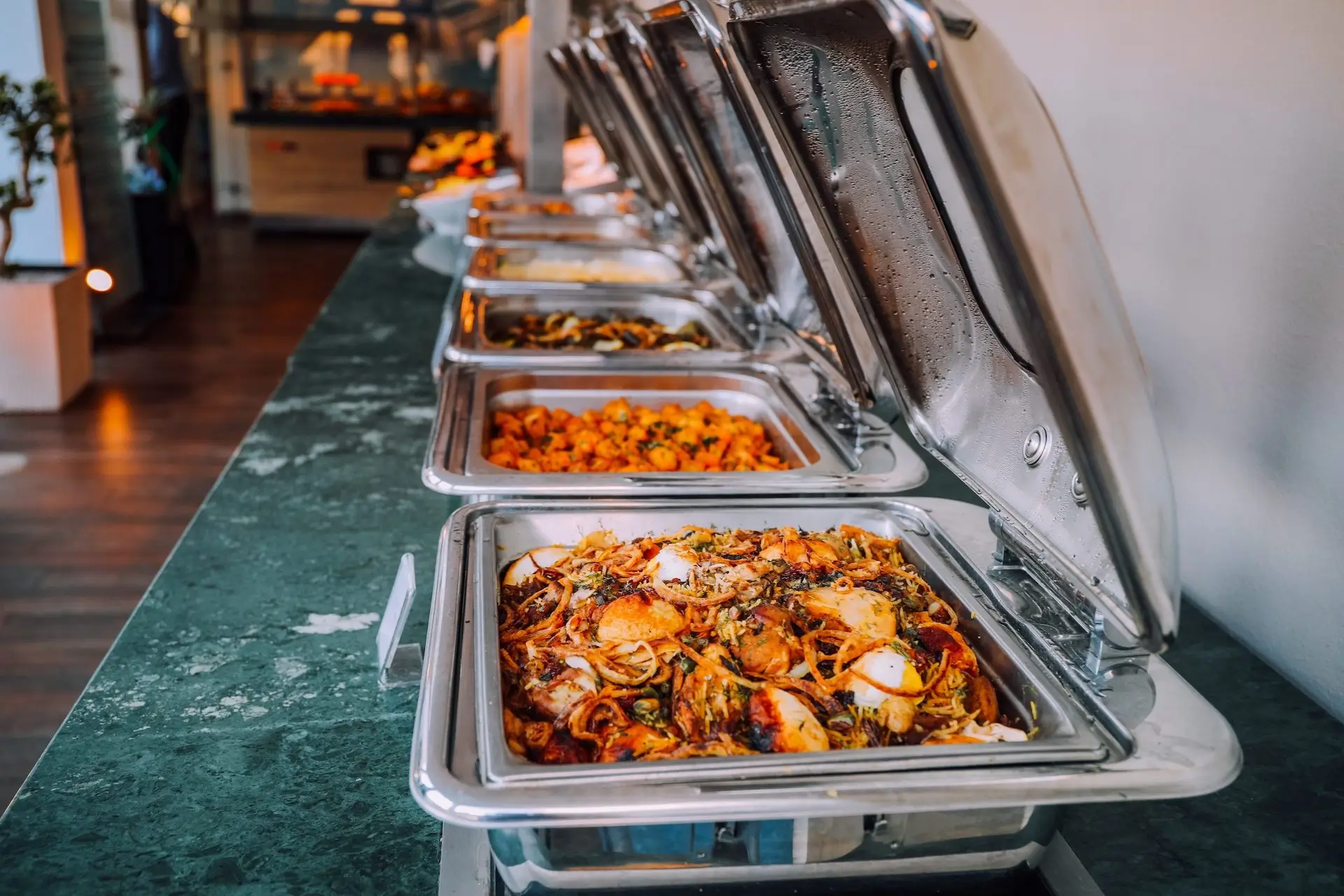 Row of trays with food in them.