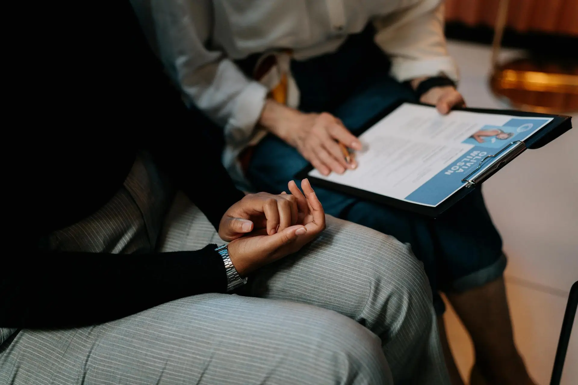 two people sat down reading over a CV