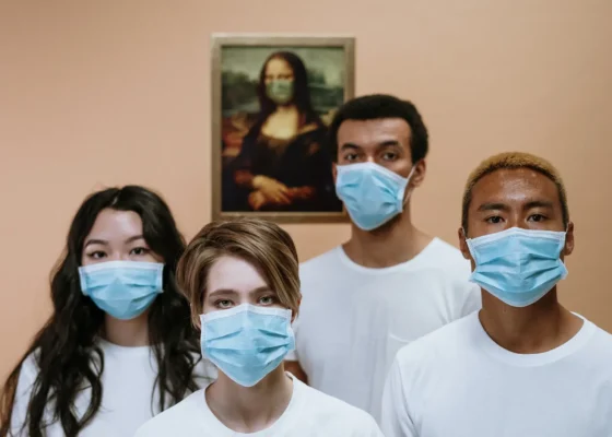 a group of individuals wearing PPE masks