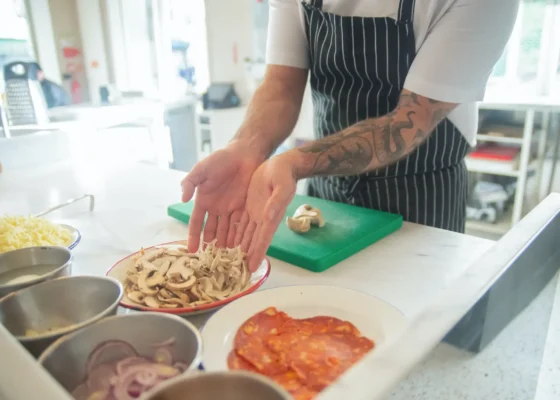 a person preparing food on a kitchen surface, separating different ingredients into different bowls