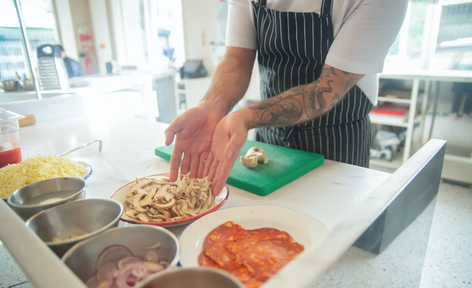 a person preparing food on a kitchen surface, separating different ingredients into different bowls