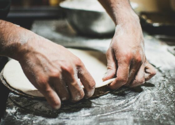 a chef pressing dough learning how to become a successful chef