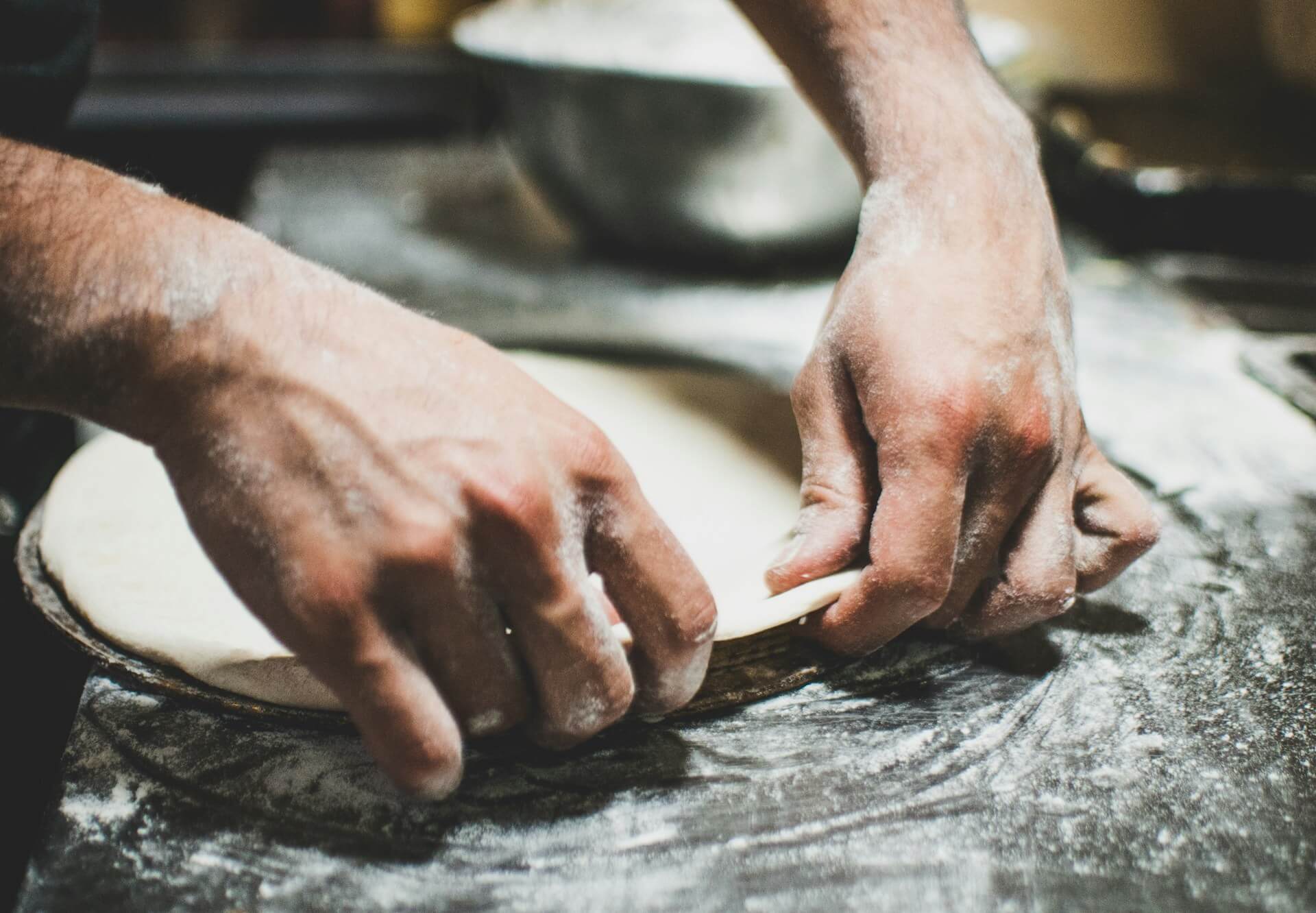 a chef pressing dough learning how to become a successful chef