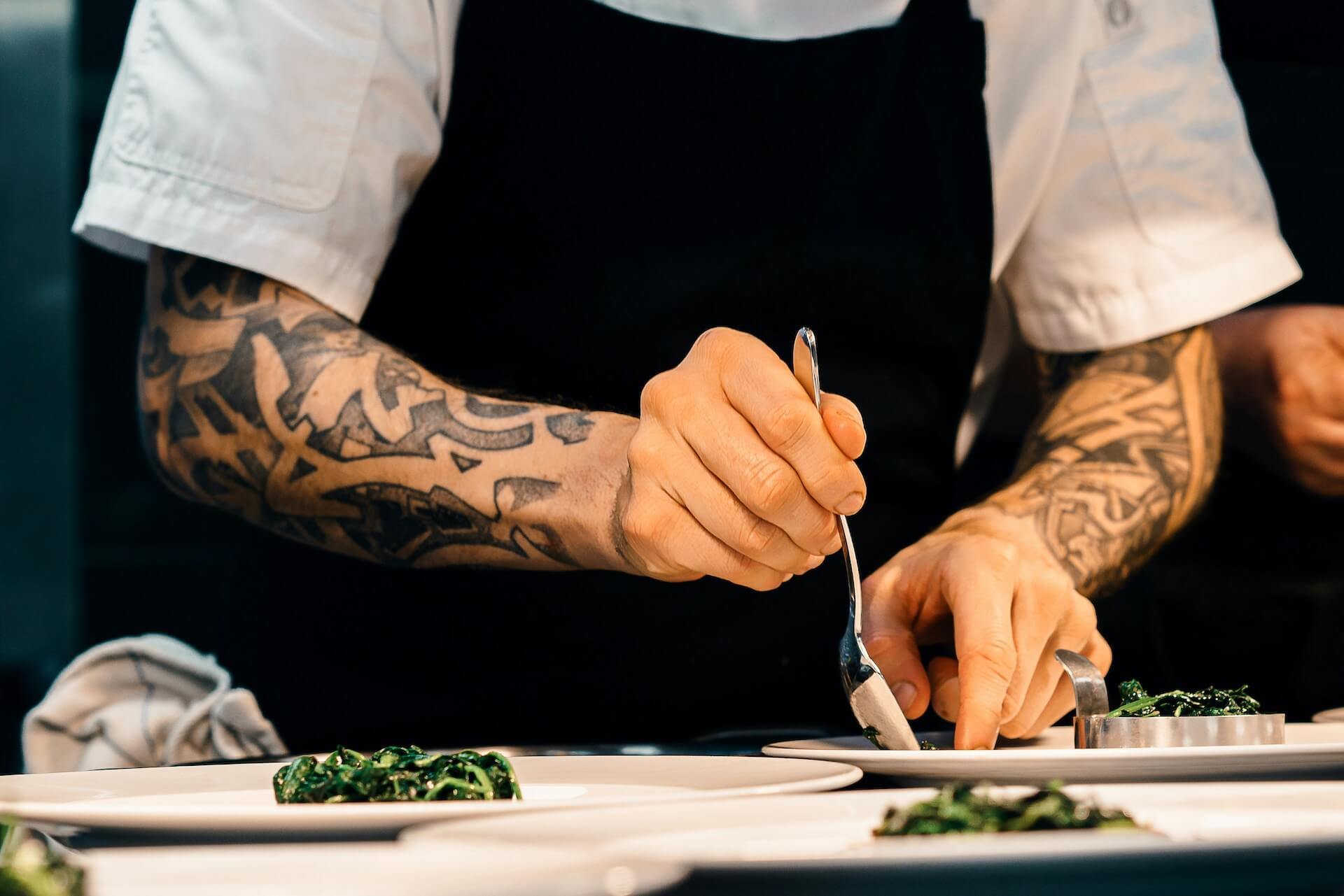 image of a chef plating up food in a kitchen