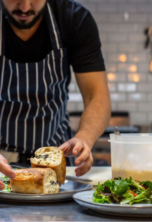 image of a caterer dishing up food in a kitchen for the what to expect from catering staff