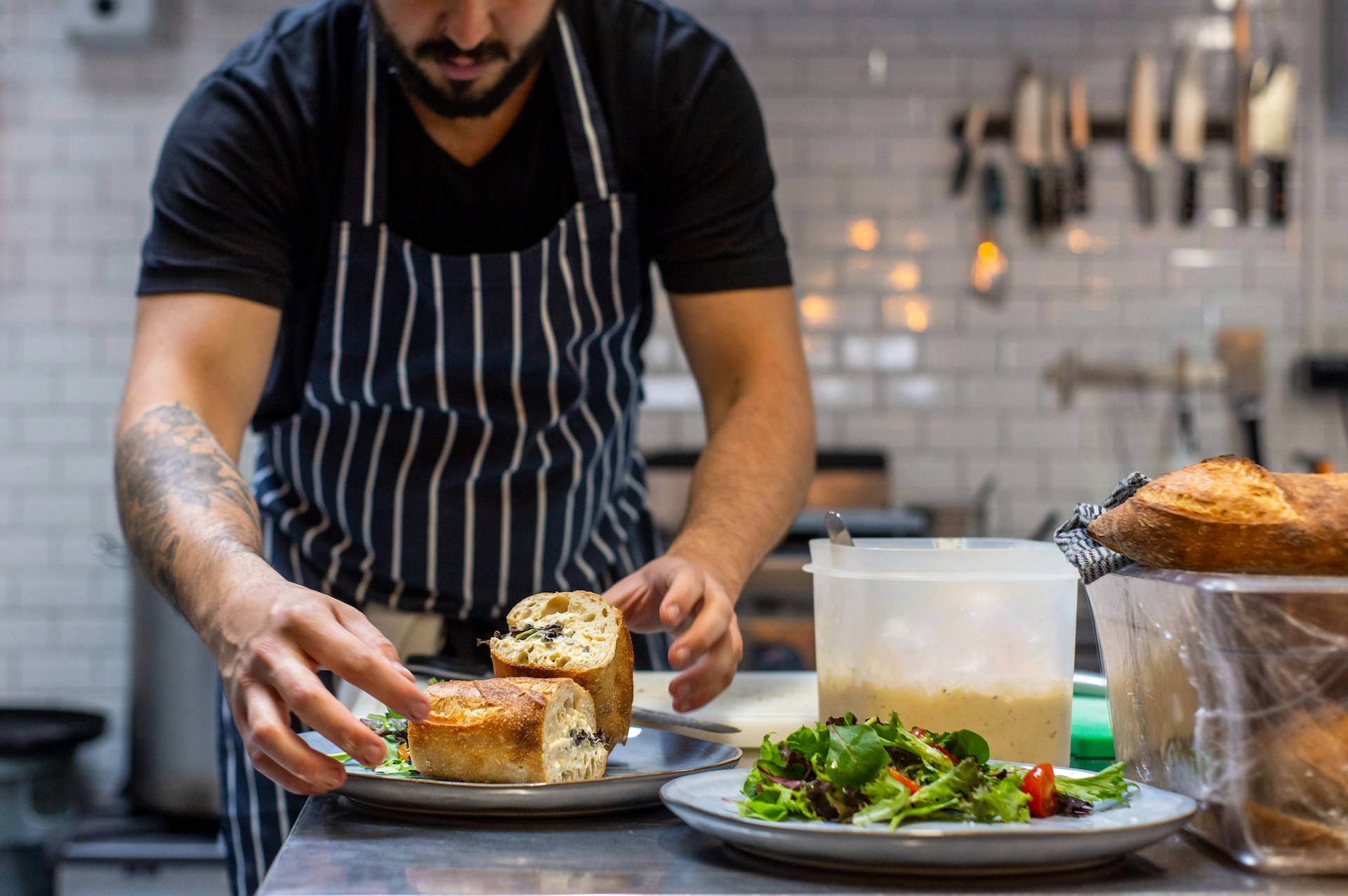 image of a caterer dishing up food in a kitchen for the what to expect from catering staff