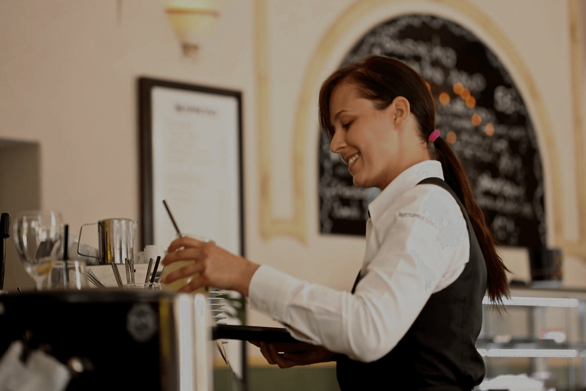 a waitress in the hospitality sector preparing to serve drinks